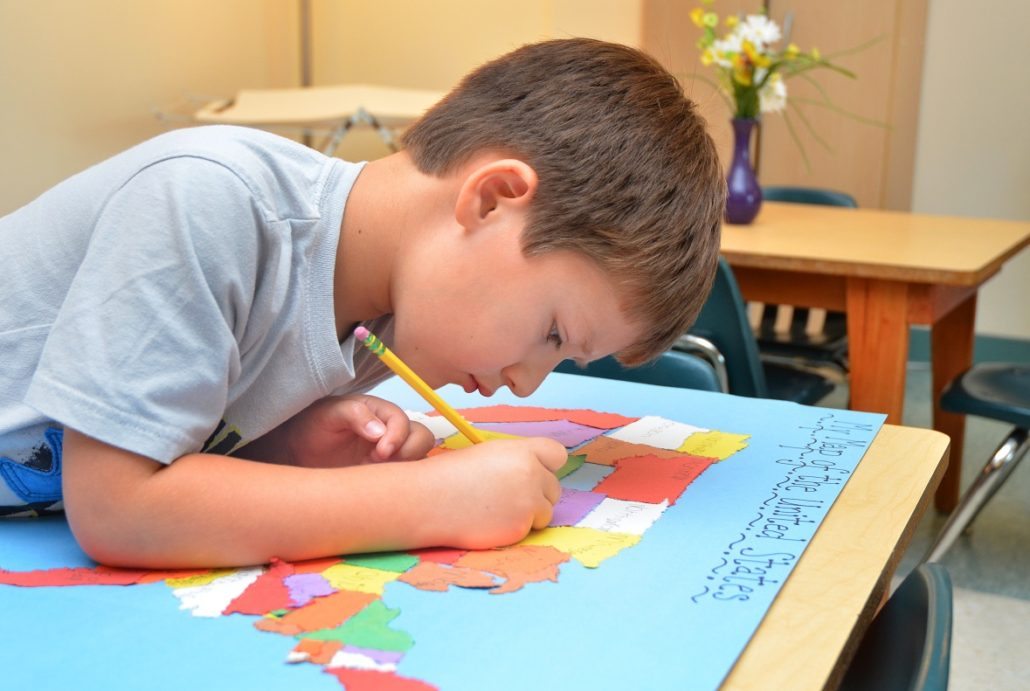 Kindergarten child doing geography work
