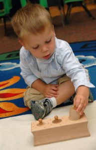 Toddler working with Montessori materials